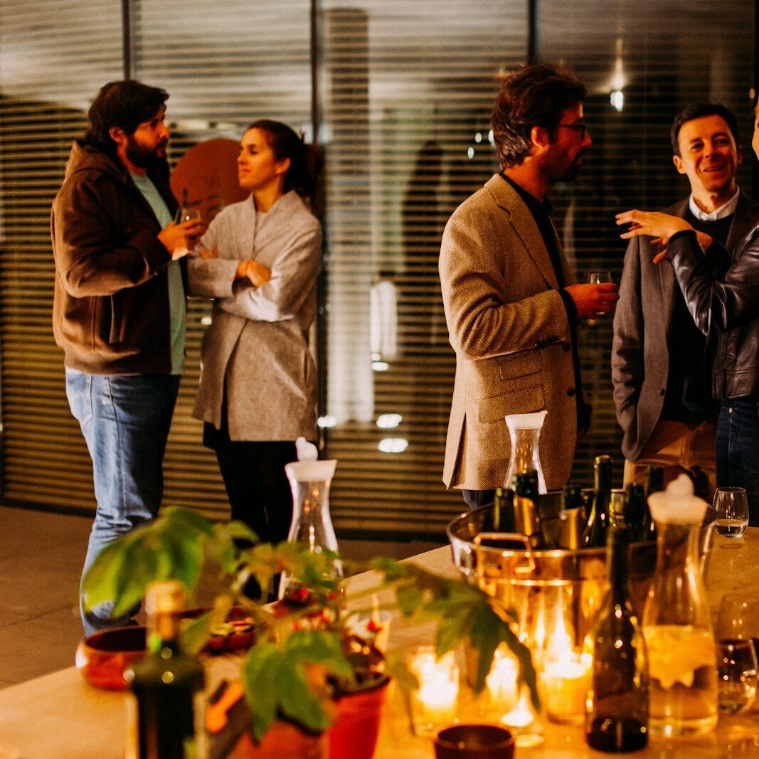 five person standing while talking each other